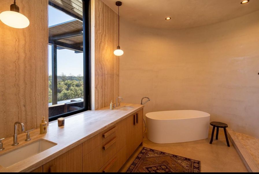 Bathroom with a soaking tub, double vanity, and recessed lighting
