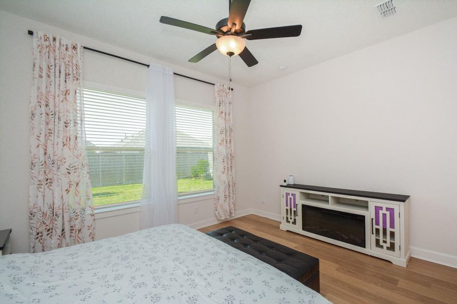 Primary Bedroom: The first-floor primary bedroom filled with natural light and generous proportions, this inviting suite offers the perfect balance of privacy, relaxation, and everyday luxury.