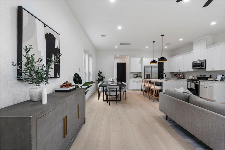 Designer perspective highlighting long sightlines from living to kitchen. Designer perspective highlighting long sightlines from living to kitchen.