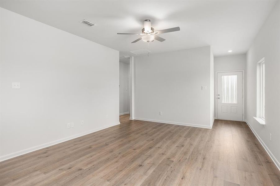 Spare room featuring light wood finished floors and ceiling fan Spare room featuring light wood finished floors and ceiling fan