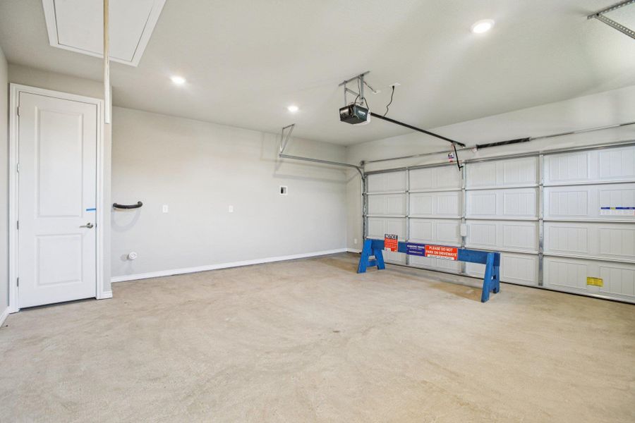 Garage featuring recessed lighting and a garage door opener