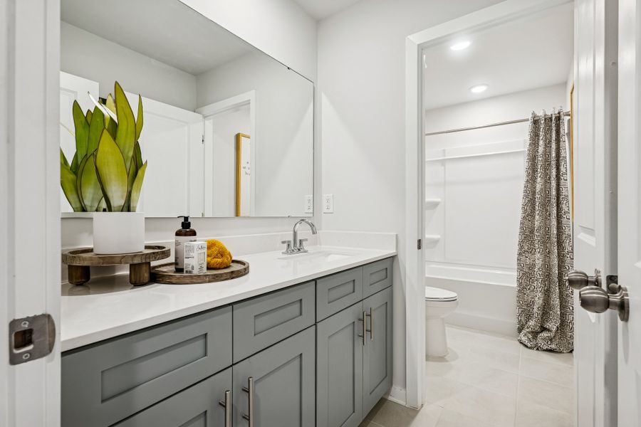 A bathroom with a sink toilet and mirror. A bathroom with a sink toilet and mirror.