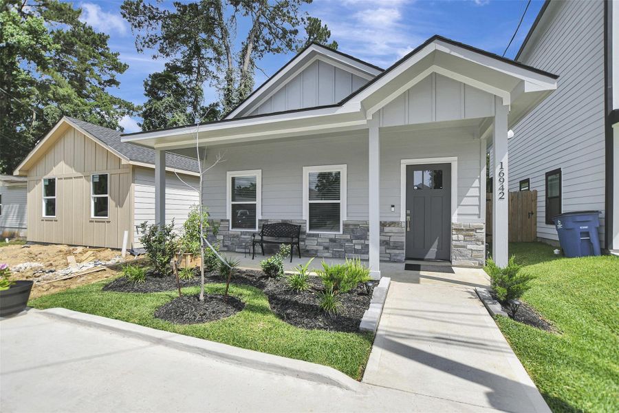 Front exterior of a new home in Lake Conroe Village, Montgomery, TX, highlighting curb appeal (Image 21).