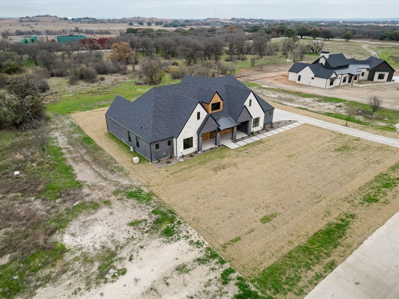 Front exterior of a new home in Summit Ranch, Aledo, TX, highlighting curb appeal (Image 29). Front exterior of a new home in Summit Ranch, Aledo, TX, highlighting curb appeal (Image 29).