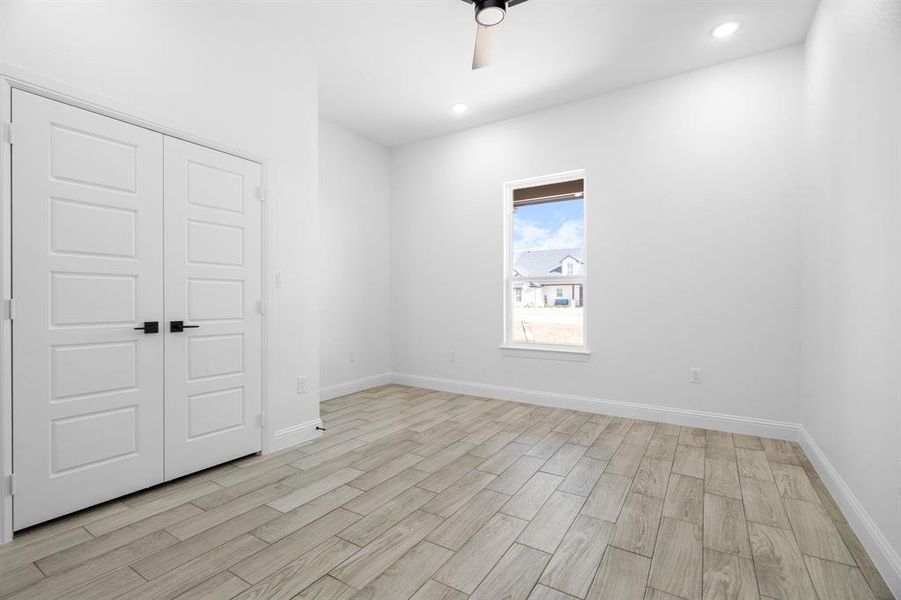 Empty room featuring ceiling fan and light hardwood / wood-style flooring