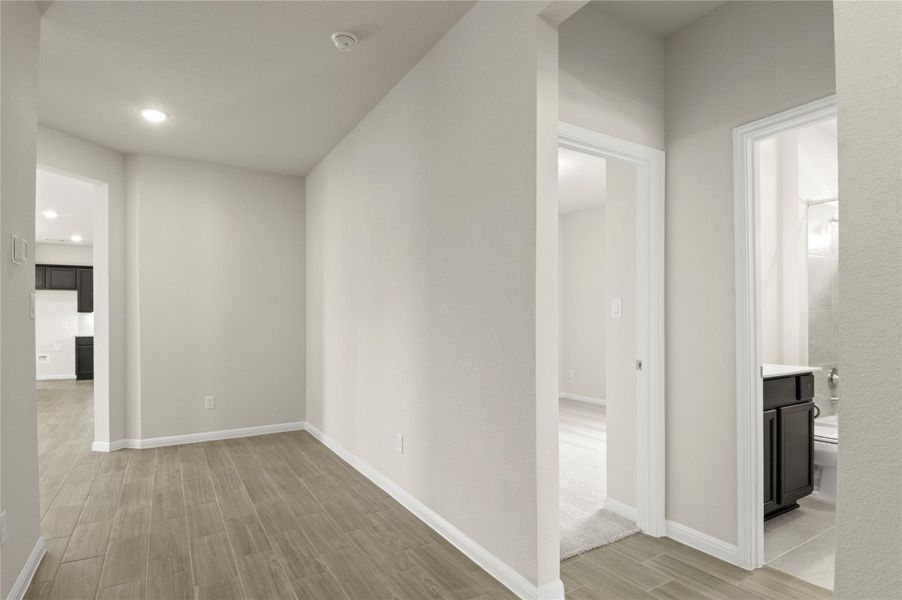 Hall with light wood-style flooring and recessed lighting