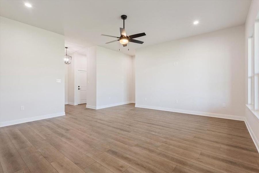 Unfurnished room with light wood-style floors, recessed lighting, and a ceiling fan Unfurnished room with light wood-style floors, recessed lighting, and a ceiling fan