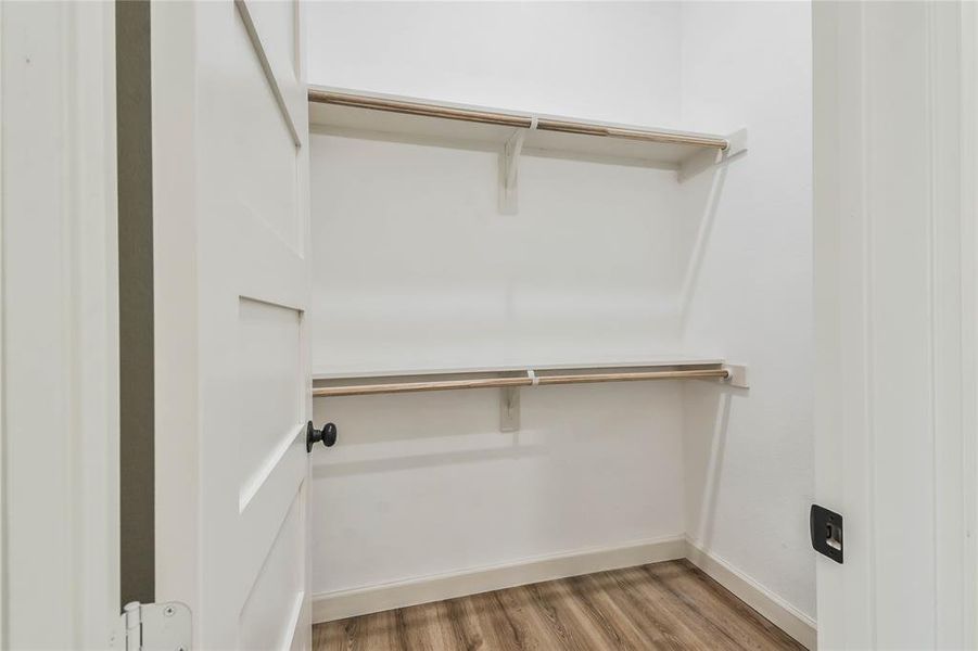 Second walk-in closet in primary bedroom.