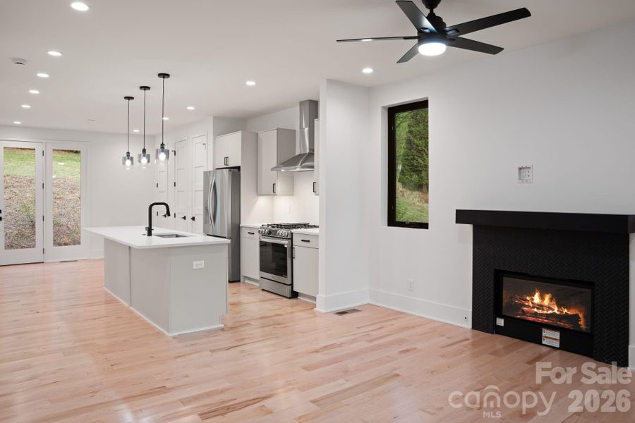 Living Room + Kitchen (fire in fireplace is digitally staged)