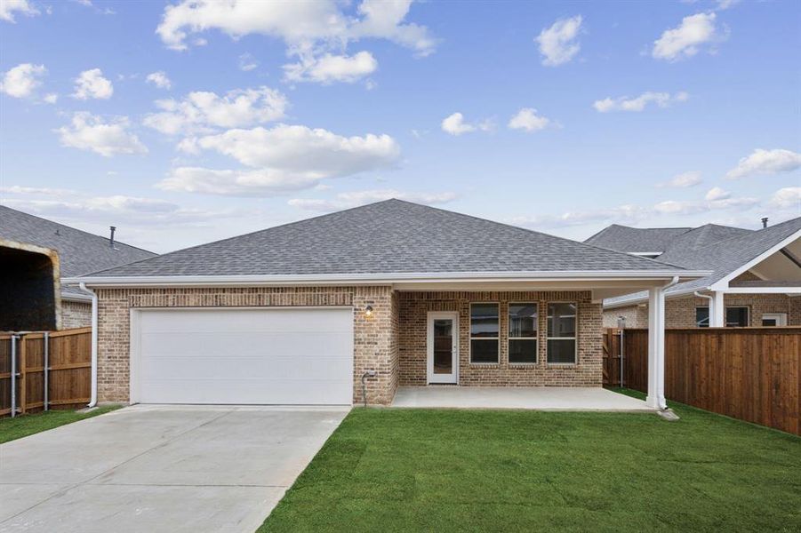 View of front of house featuring a garage and a front yard