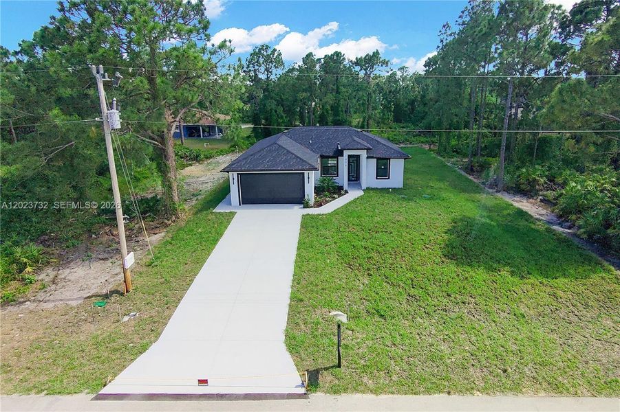Front exterior of a new home in , Lehigh Acres, FL, highlighting curb appeal (Image 30).