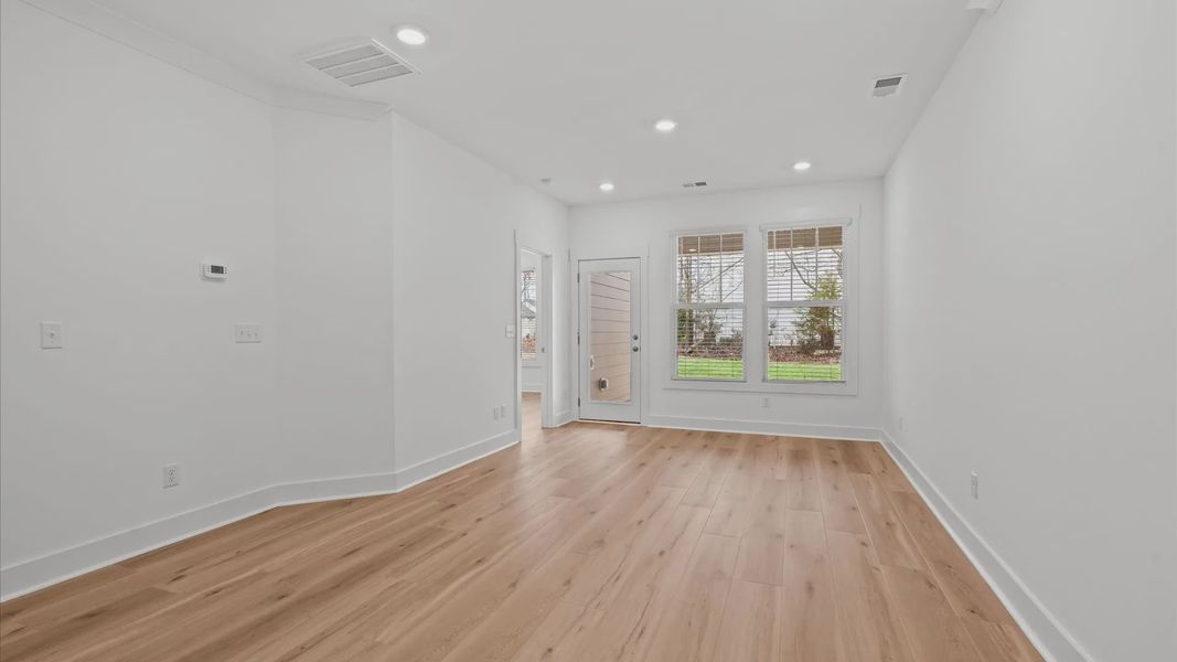 Memorable moments begin in this elegant, open family room with hardwood flooring and refined finishes at Pelham Crossing