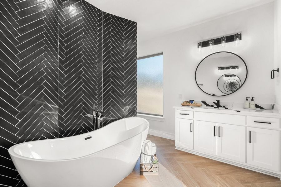 Full bathroom with vanity, a freestanding tub, tile walls, and an accent wall