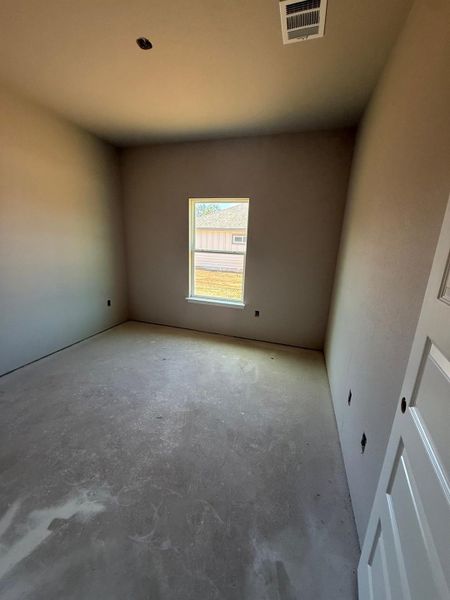 Unfurnished room featuring unfinished concrete floors
