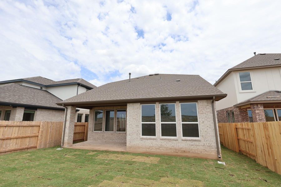 Front exterior of a new home in Flora, Hutto, TX, highlighting curb appeal (Image 2).