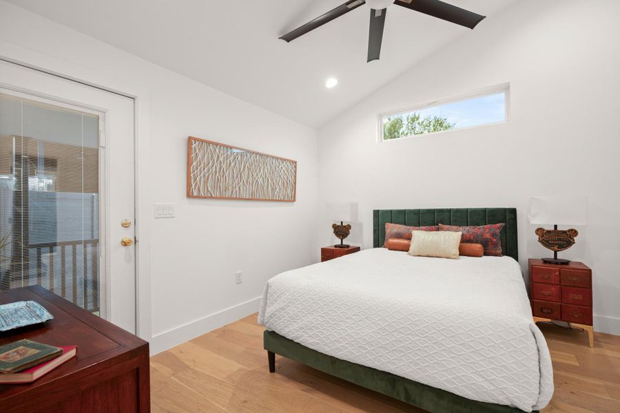 Bedroom featuring light wood-type flooring, vaulted ceiling, a ceiling fan, and recessed lighting