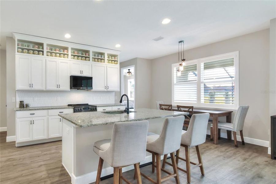 Kitchen with custom cabinetry and island seating.