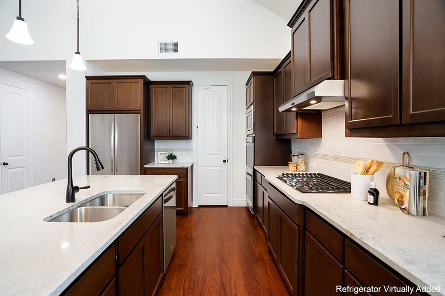 The kitchen shines with quartz countertops, stainless steel appliances, and a classic tile backsplash that never goes out of style.