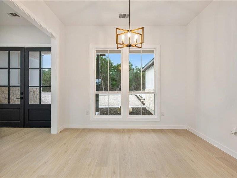 This interior space features light-toned flooring and a window providing views of the outdoors