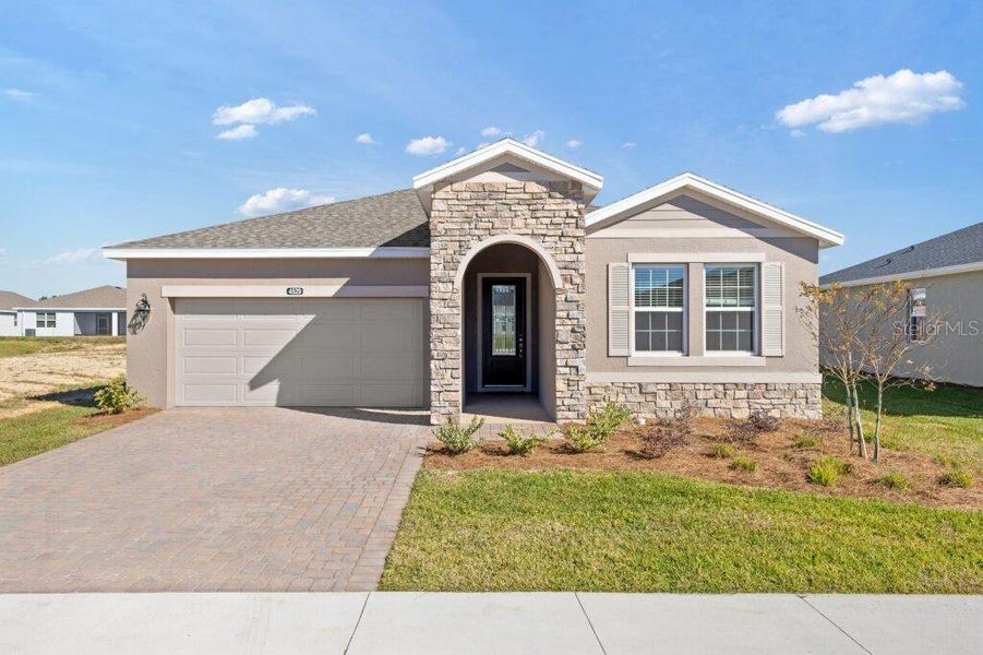 Front exterior of a new home in Ocala Preserve, Ocala, FL, highlighting curb appeal (Image 1). Front exterior of a new home in Ocala Preserve, Ocala, FL, highlighting curb appeal (Image 1).