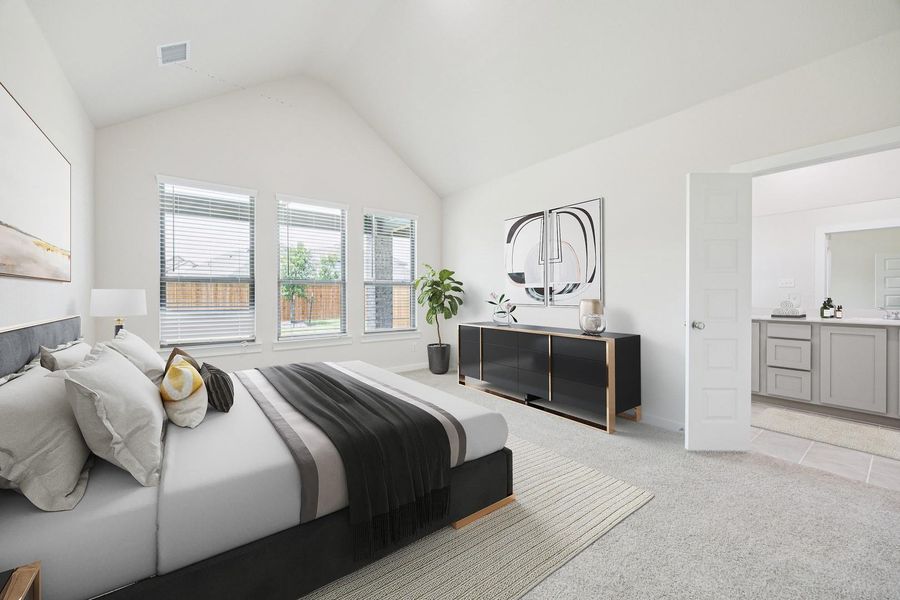 A spacious primary bedroom features an impressive vaulted ceiling and abundant natural light. A spacious primary bedroom features an impressive vaulted ceiling and abundant natural light.
