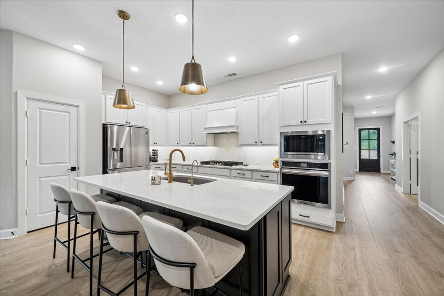 This expansive kitchen offers abundant prep space, elegant finishes, built-in oven and microwave, gas cooktop, and a thoughtfully designed open-concept layout ideal for entertaining. This expansive kitchen offers abundant prep space, elegant finishes, built-in oven and microwave, gas cooktop, and a thoughtfully designed open-concept layout ideal for entertaining.
