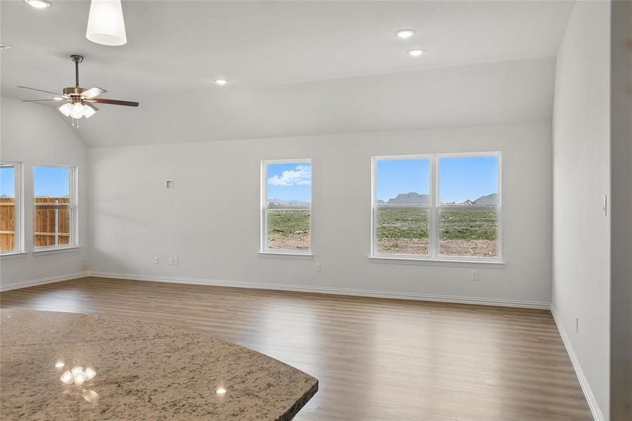 Spare room with light wood-style floors, lofted ceiling, recessed lighting, and a ceiling fan