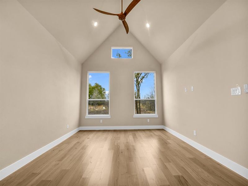 Bonus room featuring beamed ceiling, ceiling fan, high vaulted ceiling, and light hardwood / wood-style flooring