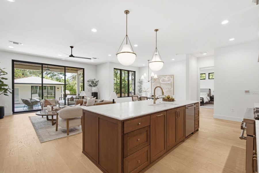 Polished hardwood floors and clean plaster walls anchor this open-concept main living space.