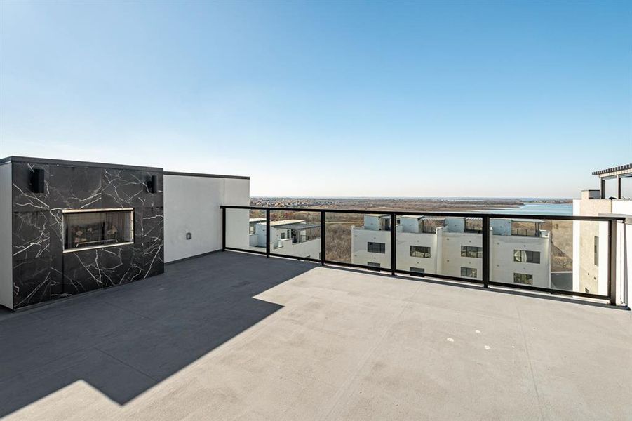 View of patio featuring a water view and a balcony