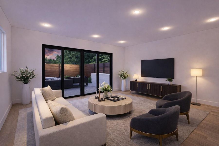 Double sliding glass doors in the first-floor living room frame views of the spacious yard and create seamless indoor-outdoor living.