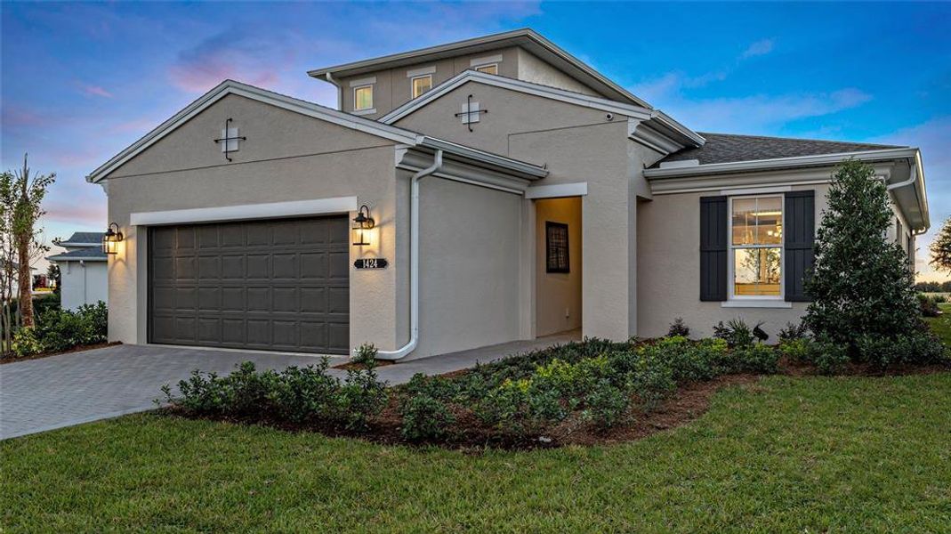 Front exterior of a new home in Cresswind at Lake Harris, Tavares, FL, highlighting curb appeal (Image 18).