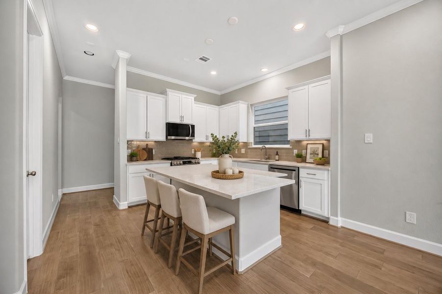 A Chef’s Dream Kitchen – Modern quartz countertops, stainless steel appliances, and a functional island make this kitchen the heart of the home. *Image Virtually Staged.*