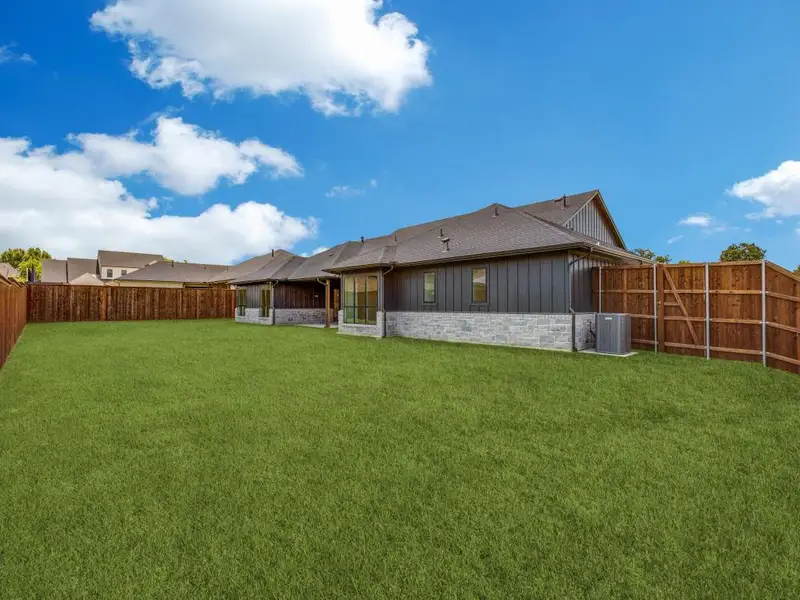 Expansive lawn with a full privacy fence Expansive lawn with a full privacy fence