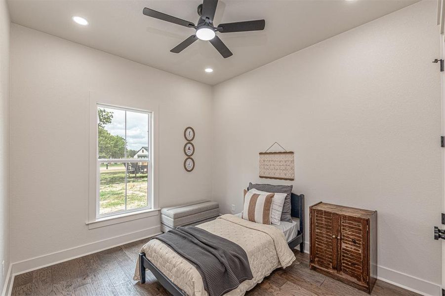 Bedroom with hardwood / wood-style floors, ceiling fan, and recessed lighting
