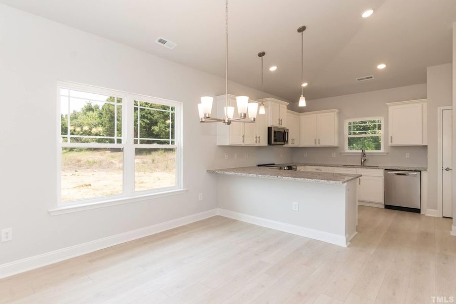 Representative furnished interior of a home built from the 1634 by Adams Homes in Parkland Place, Pace (Image 7).
