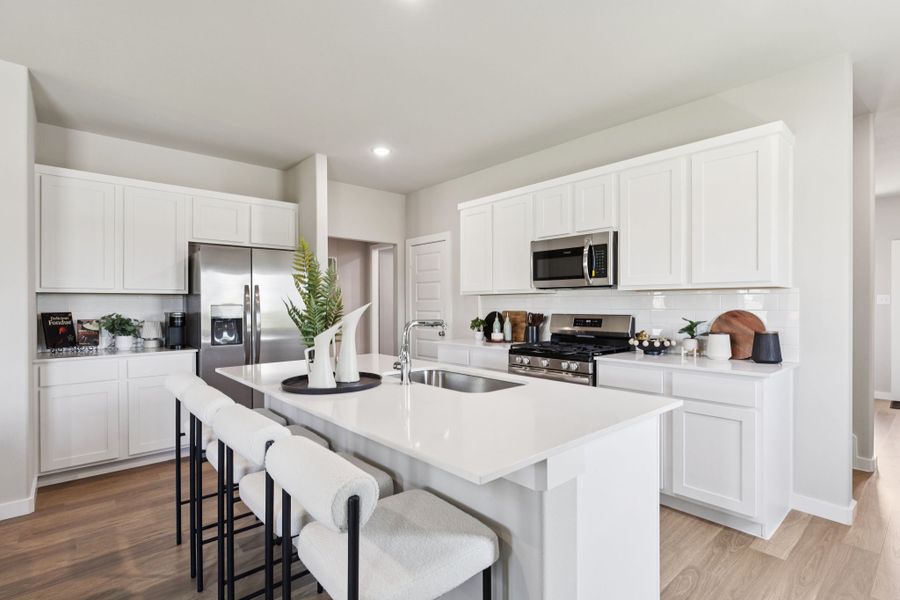 Kitchen in the Magnolia home plan by Trophy Signature Homes – REPRESENTATIVE PHOTO