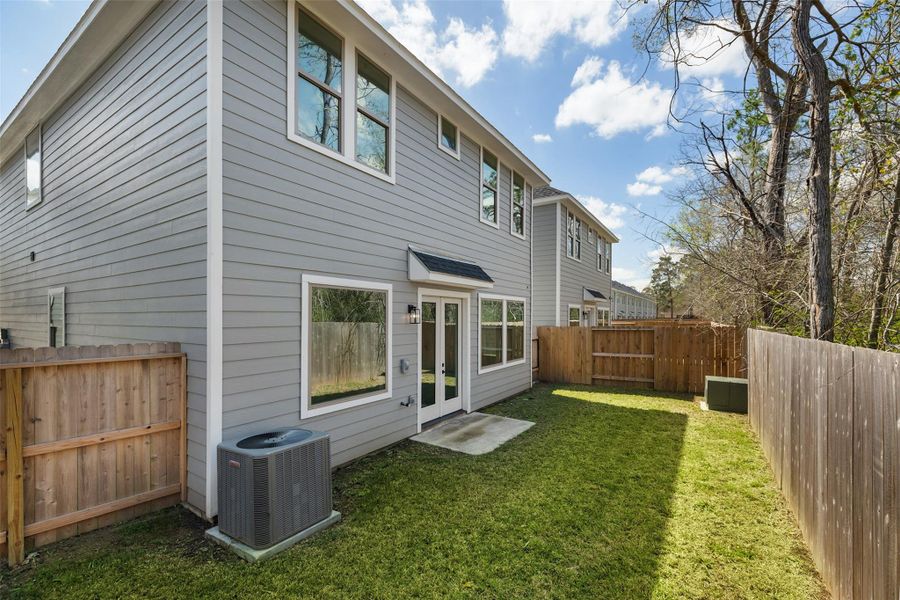 The fully fenced backyard offers both privacy and a peaceful setting, perfect for hosting gatherings or enjoying quiet moments. A row of trees along the back fence adds extra shade and enhances security, creating an inviting and tranquil outdoor retreat.