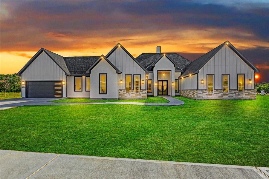 Exterior view at sunset showcasing the home's beautiful lighting and welcoming curb appeal. Exterior view at sunset showcasing the home's beautiful lighting and welcoming curb appeal.