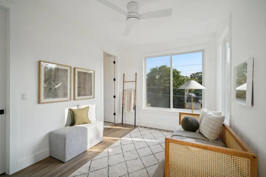 Living area with wood finished floors and ceiling fan