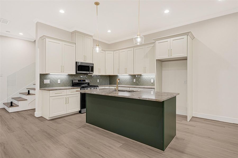 Kitchen with glass chevron green backsplash and 42' off white cabinets