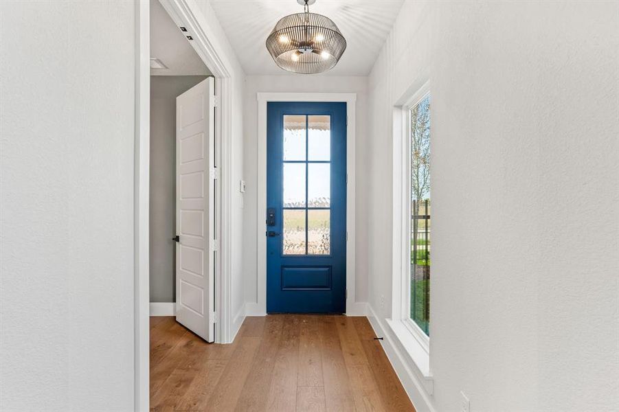 Entryway featuring light hardwood / wood-style floors and a chandelier