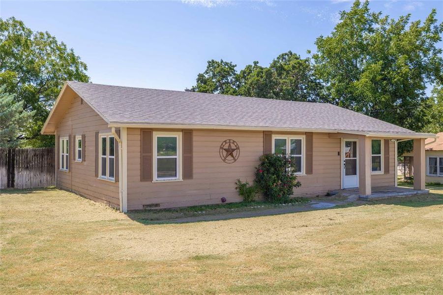 View of front of home with a shingled roof and crawl space View of front of home with a shingled roof and crawl space