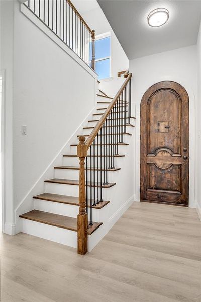 Foyer with light wood finished floors and stairway Foyer with light wood finished floors and stairway