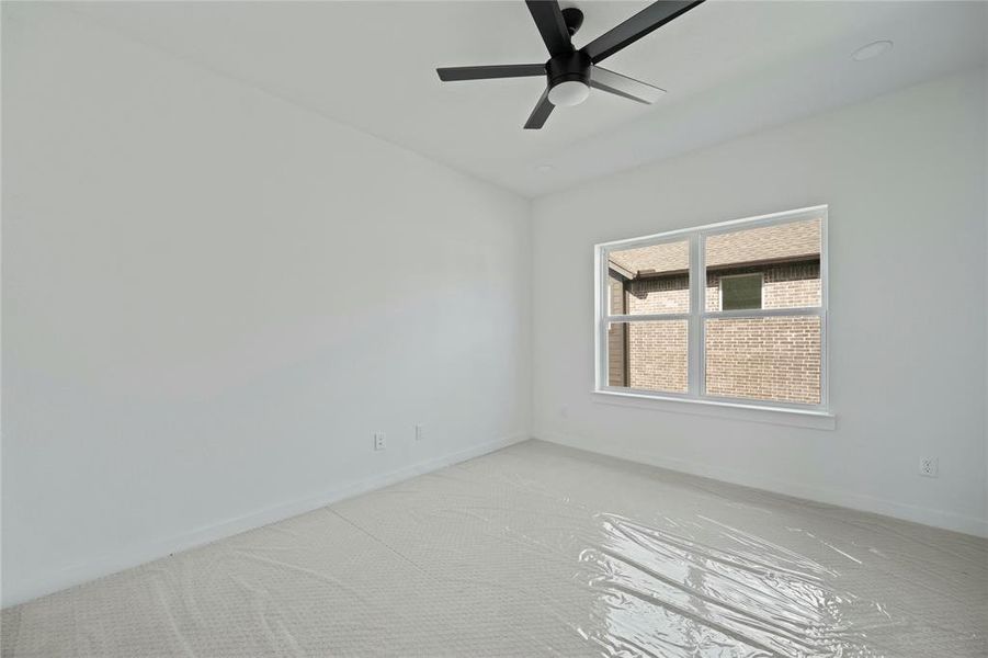 Unfurnished room with light carpet and ceiling fan Unfurnished room with light carpet and ceiling fan