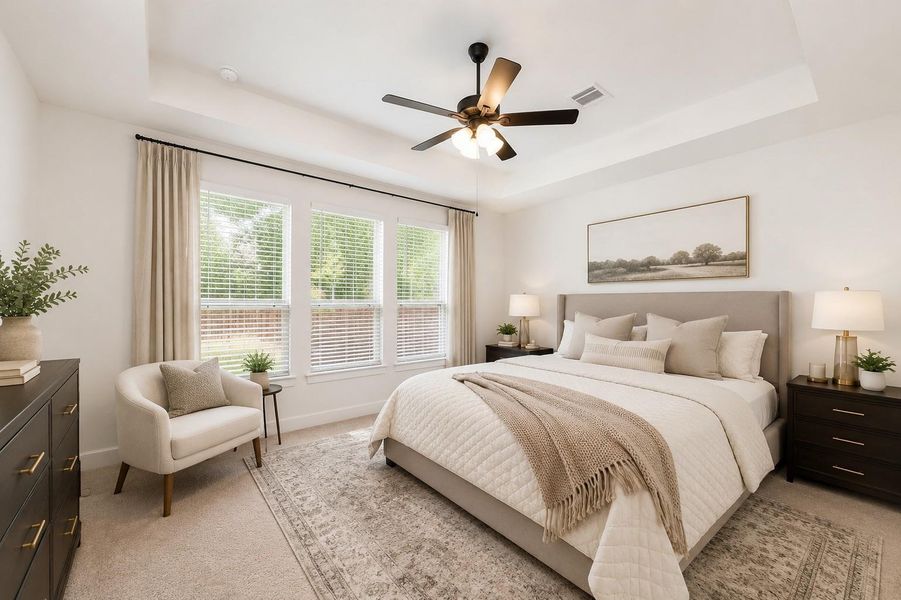 This bedroom features a cozy and elegant design with a large bed, soft neutral tones, and ample natural light from three sizable windows. It includes tasteful decor, a ceiling fan, and two bedside tables with lamps, creating a comfortable and inviting space. This bedroom features a cozy and elegant design with a large bed, soft neutral tones, and ample natural light from three sizable windows. It includes tasteful decor, a ceiling fan, and two bedside tables with lamps, creating a comfortable and inviting space.