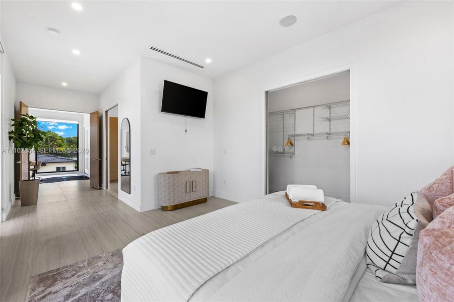 Wood-finish flooring, recessed lighting, and a closet with integrated wire shelving