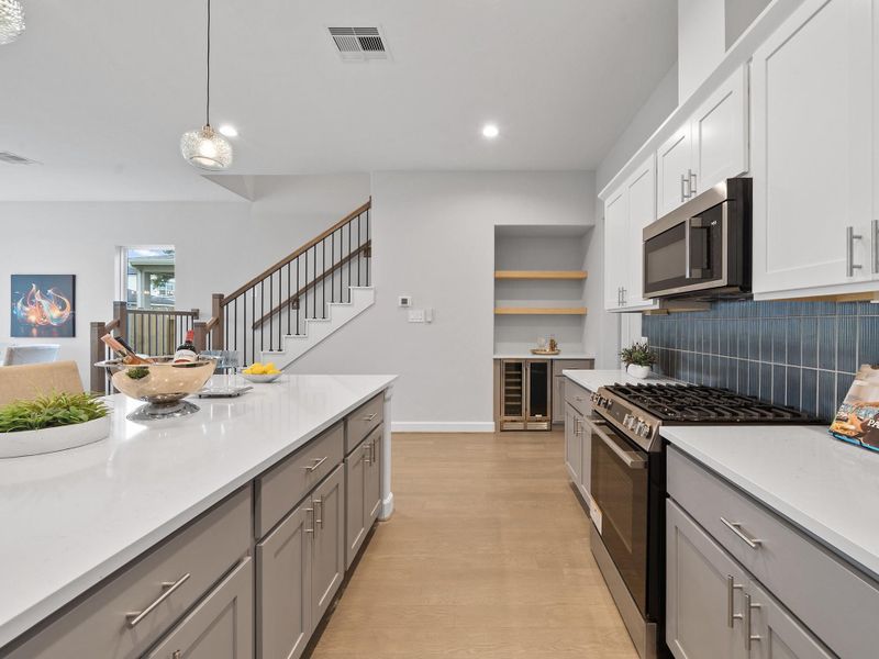 The heart of the home, this beautifully appointed kitchen blends modern style with practical functionality, creating an inviting space for cooking, gathering, and making memories. Image depicts home as-is.