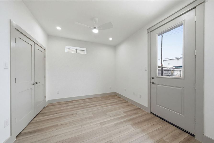 Guest bedroom on the 1st floor w door/access to yard! Double door closet on the left. Again, NO CARPET in this home