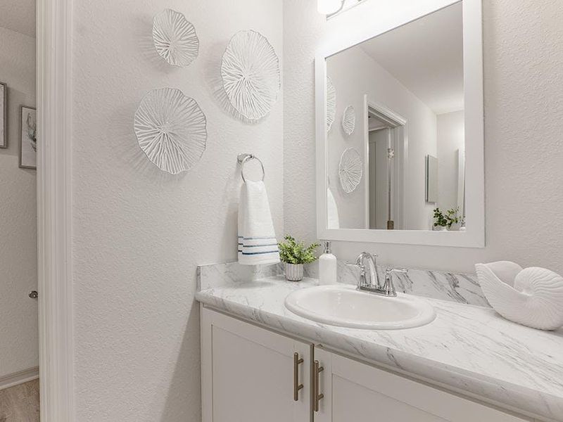 An upstairs hall bath features dual vanities and a private tub and toilet - Aspen townhome by Highland Homes An upstairs hall bath features dual vanities and a private tub and toilet - Aspen townhome by Highland Homes